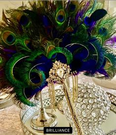 peacock feathers are displayed in a vase on a table with other decorations and accessories around it