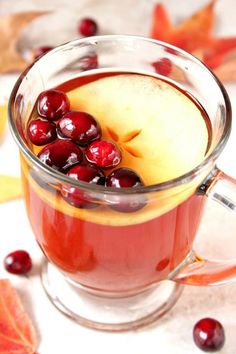 a glass mug filled with cranberry apple cider punch