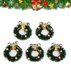 four christmas wreaths with bells hanging from them