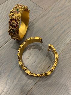 Temple bangle in matte gold and ruby stone. Detailing has the Rajasthani similarity. About an inch wide. Disclaimer: Price listed is for a single Kada. If you want to get them in a pair please select quantity 2. Ruby Stone, Matte Gold, Temple, Ruby, Bangles, Stone, Gold