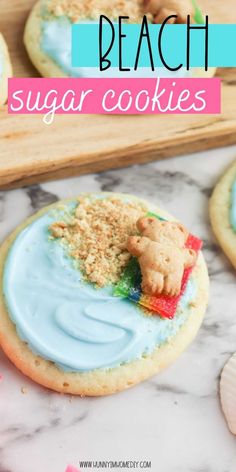 some cookies with blue icing on them and the words beach sugar cookies above it