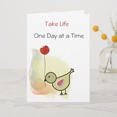 there is a card that says take life one day at a time with a bird holding a flower