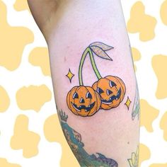 two jack o lantern pumpkins on the arm