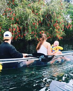 two people and a baby are in a boat