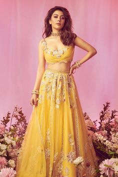 Yellow flared attached cancan lehenga in organza base with multi colored floral embroidery. Comes with pleated embroidered padded blouse and net dupatta.
Components: 3
Pattern: Embroidered
Type Of Work: Floral
Neckline: Scoop
Sleeve Type: Sleeveless
Fabric: Blouse - Net/Organza; Lehenga - Organza; Dupatta - Net
Color: Yellow
Other Details: 
Blouse:
Padded
Cutwork hem
Floral patterns
Pleated
Back cutout
Front neck depth: 8 or 8.5 inches
Closure: Side zipper
Lehenga:
Attached cancan
Linear patti
F Lemon Colour Lehenga, Yellow Aesthetic Lehenga, Fitted Net Choli With Cutdana, Yellow Organza Choli For Wedding, Organza Lehenga With Lace Work For Party, Party Lehenga In Organza With Lace Work, Festival Net Gown, Wedding Choli With Lace Work For Festivals, Haldi Outfits For Bride