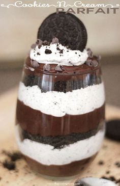 an ice cream sundae with cookies and whipped cream on top, in a glass jar