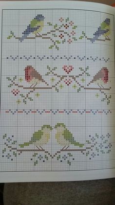 a cross stitch book with birds on it