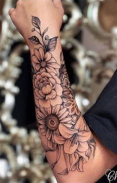 a woman's arm with flowers on it