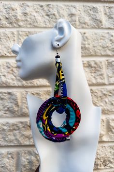 The Kitenge Swirl Earrings are a vibrant and bold accessory made from 100% cotton Ntoma fabric, also known as Ankara or Kitenge fabric. These lightweight, handmade earrings feature a striking swirl design in various colors, including black-and-white, multicolor, and gold. Inspired by Tanzanian and Maasai artistry, they add a touch of cultural elegance to any outfit, making them perfect for both casual and formal occasions. Kitenge Fabric, Ankara Earrings, Swirl Earrings, Bold Accessories, Kitenge, Maasai, Outfit Making, Swirl Design, Ring Bracelet