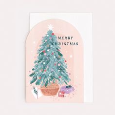 a card with a christmas tree in a pot and presents on the table next to it