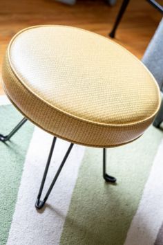 a small foot stool sitting on top of a rug