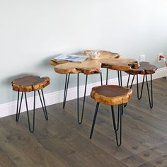 four wooden stools sitting next to each other on top of a hard wood floor