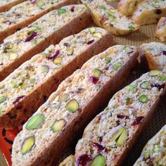 several pieces of bread with nuts and cranberry toppings