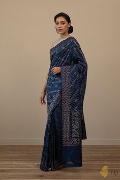 Mandira - An absolutely stunning regal Banarasi weave, handwoven in the sublime Ektara style in real zari. An exquisite aadha jaal, patterned with bootis, a koniya aanchal and the sublime Dampach weave, for a timeless Neelambari. Handcrafted to perfection in Real Silver Zari, these yards of luxury were once patronized by Mughal Royalty. Royalty, Weaving, Navy Blue