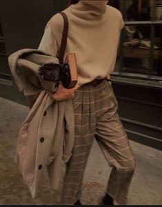 a woman is walking down the street with her purse