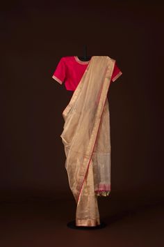 Beige gold Tissue banarasi silk kadwa border with pink raw silk backing and raw silk blouse with zari embroidery best quality saree exclusive | SILK MARK CERTIFIED is a mesmerizing ode to natural beauty and artistic finesse. Its delicately woven, evokes the serene majesty of bright landscapes. Enhanced by contrasting Pink backing borders, the saree exudes a striking allure, balancing subtlety with vibrancy.  Material Tissue silk Size 6.2 m x 1.14 m Craft Banarasi handloom Uttar Pradesh Ready to wear with fall and pico done.  Handmade Designer silk tassels adorn the pallu  SILK MARK CERTIFIED Blouse - Unstitched SAREE Craft : HandWoven Pattern : All over Purity : Pure Saree Color :Cream Saree Fabric : Ikkat Silk Saree length : 5.5 Mtrs Saree Work : Woven BORDER/PALLU Saree Border Color : Cr Gold Pre-draped Dola Silk Saree With Dupatta, Gold Chanderi Choli With Traditional Drape, Pink Raw Silk Pre-draped Saree With Dupatta, Gold Anarkali Raw Silk Traditional Wear, Gold Raw Silk Traditional Wear For Navratri, Gold Chandbali Raw Silk Choli, Gold Chandbali Pre-draped Saree For Diwali, Diwali Gold Pre-draped Chandbali Saree, Designer Raw Silk Pink Saree