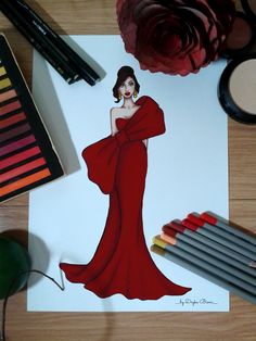 a drawing of a woman in a red dress next to crayons and markers