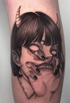 a woman with horns and fangs on her leg