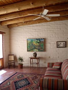 a living room filled with furniture and a ceiling fan