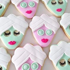 decorated cookies are arranged in the shape of women's faces