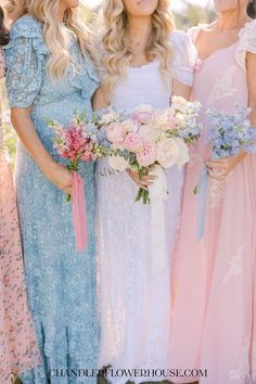 the bridesmaids are all dressed in pastel dresses and holding their bouquets