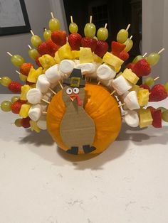 a turkey made out of fruit and marshmallows on top of a table