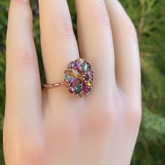 This detailed ring design is inspired by the chrysanthe flower. The ring is made out of seventeen natural colored tourmaline stones and S925 sterling silver with 18k plated gold. The floral and multicolor design represent youth and sunshine, which makes it a memorable gift for her. The ring can easily match all your occasions and outfits. Also, the adjustable ring size is designed to fit all finger sizes. Size: Adjustable and fitable for all All orders come with a unique ring box and gift bag. G Oval Multi-stone Flower Ring Gift, Adjustable Gemstone Flower Ring For Anniversary, Fine Jewelry Multi-stone Flower Ring Gift, Multi-stone Flower Ring Fine Jewelry Gift, Oval Multi-stone Flower Ring For Anniversary, Gift Jewelry With Multicolor Rose Cut Diamonds, Multicolor Rose Cut Diamond Jewelry Gift, Unique Ring Box, Tourmaline Jewelry