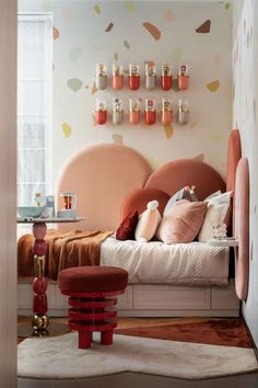 a bedroom with pink and orange decor on the walls