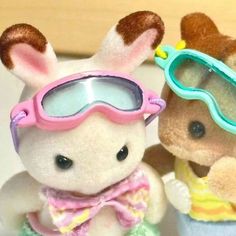 two stuffed animals with sunglasses on their heads