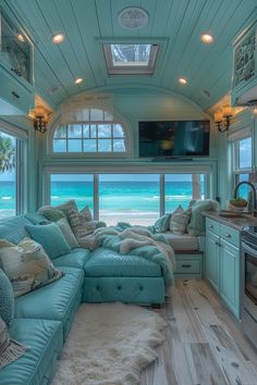 a living room filled with furniture next to an ocean view