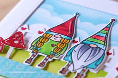 a close up of a card with two gnomes