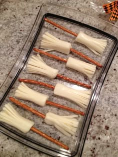 carrots and cheese sticks are arranged on a baking sheet in preparation to be cooked