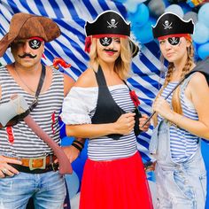 three people in pirate costumes posing for a photo