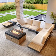 an outdoor living area with couches, tables and a fire pit in the center