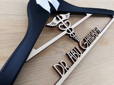 a pair of scissors sitting on top of a wooden table next to the words doctor and nurse