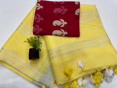 This is a beautiful organic cotton handloom saree with silver zari border and zari lines pallu design . Fabric - Cotton  Technique - Handloom Saree length - 5.5 mtr. Blouse - 1 mtr. Pure cambric cotton blouse in contrast print . Easy wash and care . Please note - color may be vary a little due to sunlight and photography . Please message us after purchasing in case you want fall and Pico done it not . No extra charges for fall and Pico but inform us . Blouse stitching is also available . Yellow Self Design Cotton Blouse Piece, Yellow Cotton Blouse Piece With Self Design, Yellow Cotton Saree With Self Design, Cotton Blouse Piece With Border For Festivals, Diwali Cotton Blouse Piece With Border, Yellow Cotton Blouse Piece For Puja, Yellow Cotton Dupatta With Zari Weaving, Yellow Cotton Saree With Cutdana, Yellow Cotton Saree With Zari Weaving