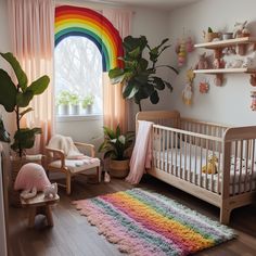 a child's room with a rainbow rug, crib and potted plants