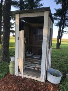 an outhouse in the middle of a field