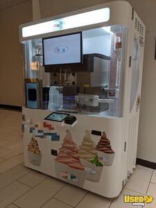 an ice cream vending machine is shown in the middle of a tiled floored area