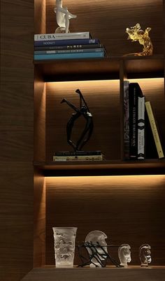 a book shelf filled with books and vases on top of wooden shelves next to each other