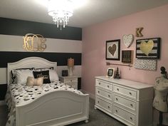 a bedroom decorated in black, white and pink