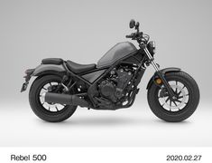 a black motorcycle parked on top of a white floor next to a gray wall with the words rebel 500 written below it