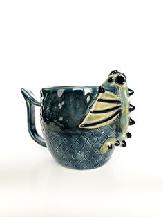 a ceramic mug with a fish on it