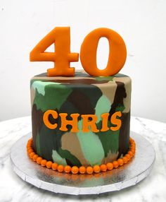 a birthday cake with the number 40 on it, decorated in camo and orange