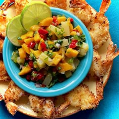 a blue bowl filled with food on top of a plate