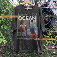 a t - shirt hanging on a fence with the words frank frank ocean in it