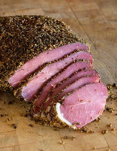 a sliced ham on a cutting board with seasoning