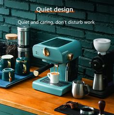 a coffee maker sitting on top of a wooden counter next to cups and mugs