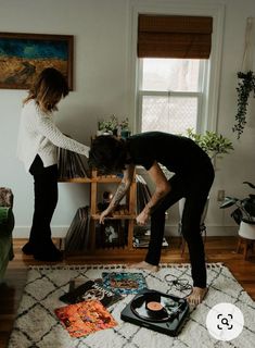 a woman standing on top of a rug next to a record player