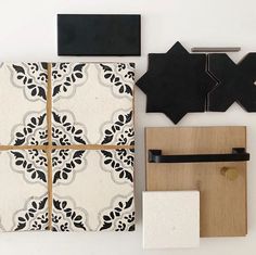 various tiles and accessories are arranged on a white surface with black trim around the edges